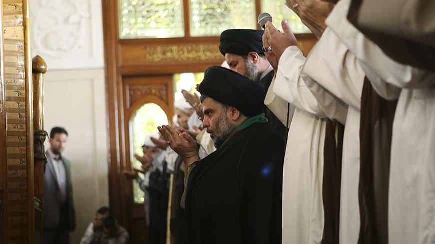 Iraqi Shi'ite radical cleric Muqtada al-Sadr (C) takes part in Friday prayers at the Kufa mosque near Najaf, 160 km (100 miles) south of Baghdad May 10, 2013. REUTERS/Ahmad Mousa (IRAQ - Tags: RELIGION) - RTXZHC5