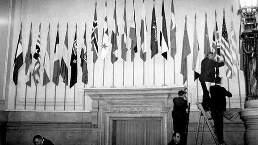 January 1946:  The flags of the United Nations being put up over the main entrance hall in Central Hall.  (Photo by Topical Press Agency/Getty Images)