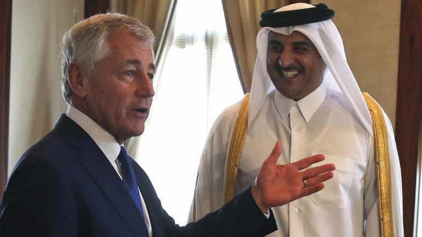 U.S. Secretary of Defense Chuck Hagel (L) meets with Qatar's Emir Sheikh Tamim bin Hamad in Doha December 10, 2013. Hagel briefed Qatari leaders on Tuesday about the effort to destroy Syria's chemical weapons, and he underscored U.S. support for Syria's moderate opposition. Picture taken December 10, 2013,  REUTERS/Mark Wilson/Pool  (QATAR - Tags: POLITICS) - RTX16DFR