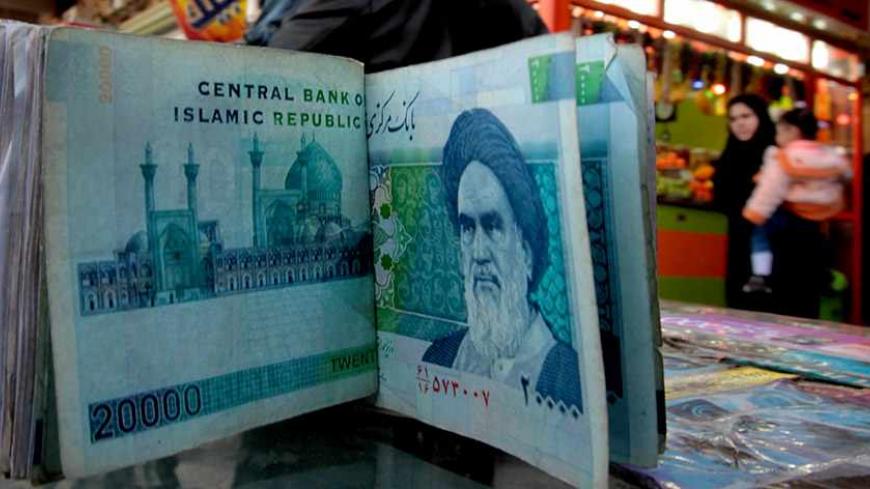 An Iraqi money dealer counts Iranian rial banknotes bearing a portrait of the late founder of the Islamic Republic of Iran, Ayatollah Ruhollah Khomeini, at an exchange office in Baghdad on February 3, 2012. Tens of thousands of Iranian visitors have been finding difficulty in using the Iranian currency in Iraq due to a depreciation of the rial against the dollar. AFP PHOTO/ ALI AL-SAADI (Photo credit should read ALI AL-SAADI/AFP/Getty Images)