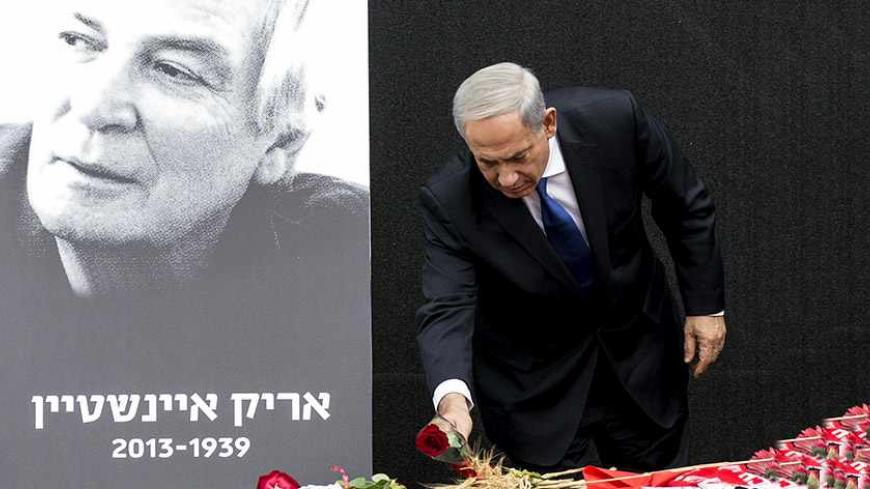 Israeli Prime Minister Benjamin Netanyahu lays a flower on the coffin of legendary Israeli singer Arik Einstein during his memorial service in the Mediterranean coastal city of Tel Aviv, on November 27, 2013. Einstein, 74, died at Ichilov hospital after being taken there earlier in the week due to heart complications, the director of the Tel Aviv medical centre said. AFP PHOTO / JACK GUEZ        (Photo credit should read JACK GUEZ/AFP/Getty Images)