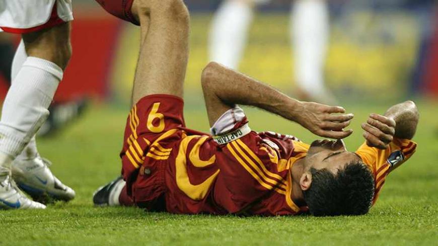 Galatasaray's Hakan Sukur lies on the pitch during their UEFA Cup first round first leg soccer match against Sion at the Stade de Geneve in Geneva September 20, 2007.  REUTERS/Denis Balibouse   (SWITZERLAND) - RTR1U2VI