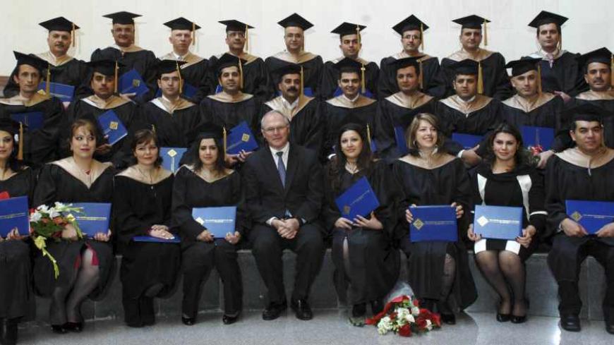 U.S. Ambassador to Iraq Christopher Hill poses with students of the American University of Iraq during their graduation ceremony in Sulaimaniya, about 260 km (160 miles) northeast of Baghdad, January 26, 2010. Picture taken January 26, 2010.   REUTERS/Jamal Penjweny (IRAQ - Tags: EDUCATION POLITICS) - RTR29IK1