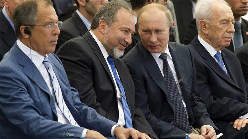Israel's Foreign Minister Avigdor Lieberman (2nd L) listens to Russia's President Vladimir Putin (3rd L) as Russia's Foreign Minister Sergei Lavrov (L) and Israel's President Shimon Peres (R) sit beside them during an unveiling ceremony for a monument commemorating the victory of the Soviet Red Army in World War Two in the coastal city of Netanya, north of Tel Aviv June 25, 2012. Peres on Monday urged visiting Putin to take steps to avert the threat of a nuclear-armed Iran and to stop the bloodshed in Syria