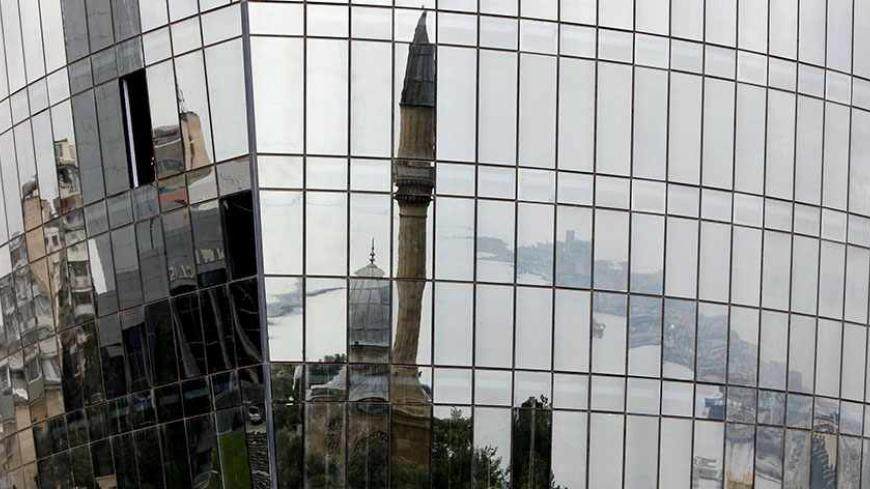 A mosque and the city waterfront are reflected in a new building in the Azeri capital Baku, September 8, 2012. Rising tension between Armenia and Azerbaijan could unleash a new war over the disputed Nagorno-Karabakh region that spreads beyond the countries borders and has global significance, the breakaway republic leader said. Picture taken September 8, 2012.  To match AZERBAIJAN-ARMENIA/CONFLICT      REUTERS/David Mdzinarishvili (AZERBAIJAN - Tags: POLITICS CITYSPACE RELIGION TPX IMAGES OF THE DAY) - RTR3