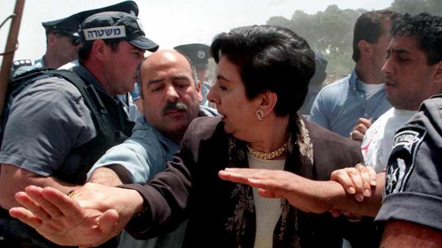 Prominent Palestinian human rights advocate hanan Ashrawi is protected by a Palestinians who tries to keep Israeli riot police from pushing her during scuffles which broke out May 27 at the Ras Al-Amud settlement complex under construction in Arab East Jerusalem. Israeli police say they had to use force to prevent the Palestinian demonstrators from pushing their way into the construction site during a demonstration against the continuing building restarted after months of suspension.

JWH/GB - RTRPJGB