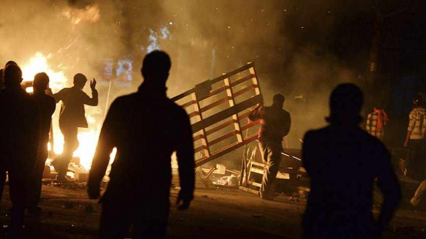 Demonstrators set barricades on fire as they clash with riot police during a protest in the Tuzlucayir neighbourhood of Ankara September 9, 2013. Billed as a symbol of peace between two faiths, a new place of worship has turned Tuzlucayir, a poor suburb of Ankara, into a battleground and exposed wider sectarian tensions within Turkey. The project's blueprint envisages a Sunni mosque rising side by side with a new cemevi, or assembly house, to be used by Alevis, Turkey's biggest religious minority. But with 