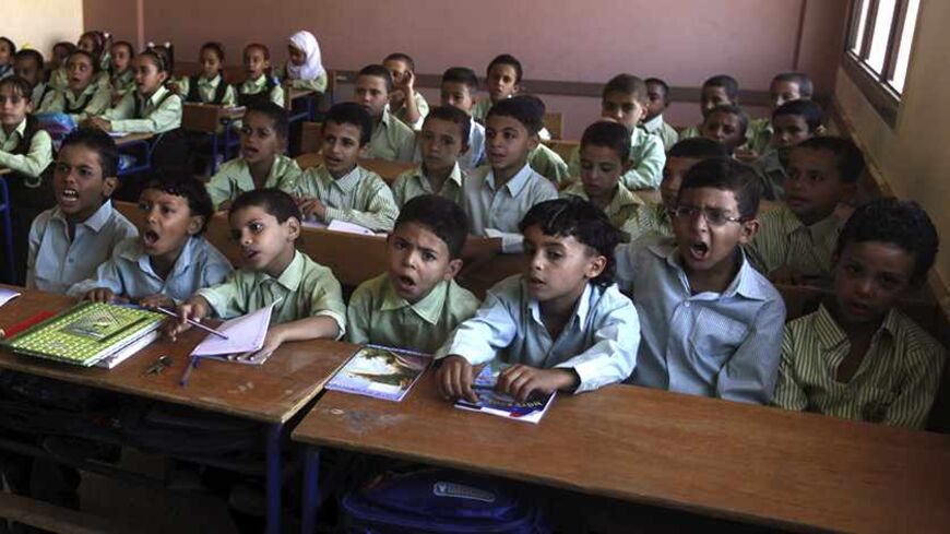 Students attend a class on the first day of their new school year at a government school in Giza, south of Cairo September 22, 2013. Students resumed their studies at the beginning of the new academic year this weekend amid parental concerns of a possible lack of security after the summer vacation ends. REUTERS/Mohamed Abd El Ghany  (EGYPT - Tags: POLITICS EDUCATION) - RTX13UJJ