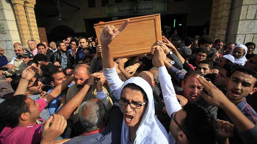 People carry the coffin of Mohamed Reda, a first-year student in the faculty of engineering, during his funeral service at Al Sayyida Nafisa mosque in Cairo November 29, 2013. Reda was killed in clashes between supporters of ousted Islamist President Mohamed Mursi and security forces at Cairo University on Thursday, medical sources said. REUTERS/Amr Abdallah Dalsh  (EGYPT - Tags: POLITICS CIVIL UNREST TPX IMAGES OF THE DAY) - RTX15XDZ