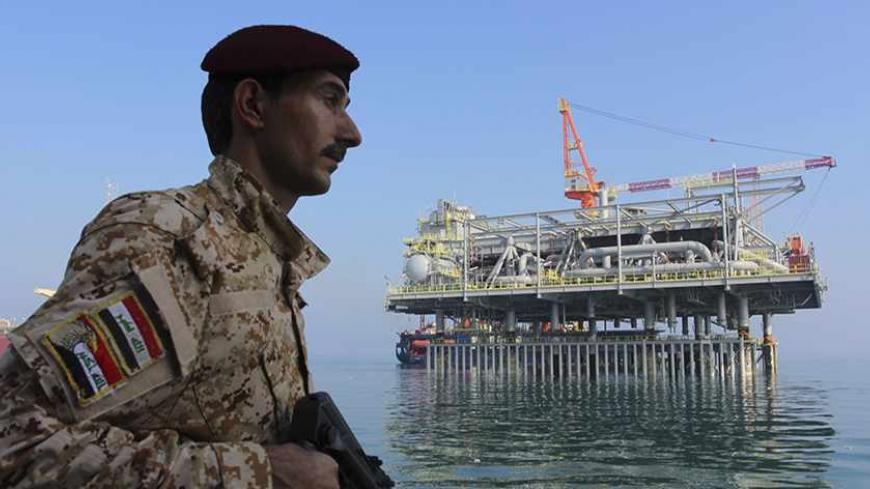 An Iraqi soldier stands guard near the Central Metering and Manifold platform (CMMP) at Al Basra oil terminal in the Middle East Gulf November 27, 2013.  The Southern Oil Company is preparing a new Central Metering and Manifold Platform to increase oil export capacity. It will be operational in the first quarter of next year, according to Associate Director Mahmoud Abdul Amir. Picture taken November 27, 2013.  REUTERS/Essam Al-Sudani (IRAQ - Tags: ENERGY) - RTX163GO