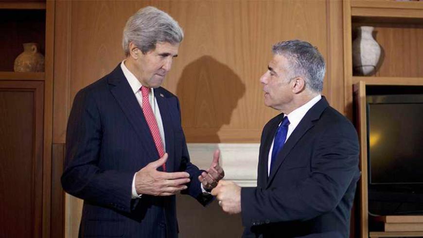 U.S. Secretary of State John Kerry (L) talks to Israel's Finance Minister Yair Lapid before their meeting in Jerusalem December 6, 2013. REUTERS/Pablo Martinez Monsivais/Pool (JERUSALEM - Tags: POLITICS BUSINESS) - RTX1665G