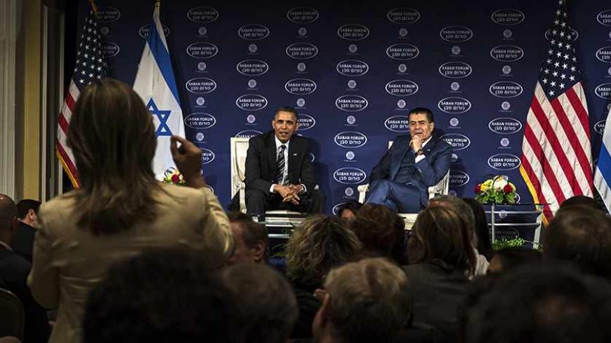 U.S. President Barack Obama (L) takes questions from the audience after a conversation with Israeli-American media tycoon Haim Saban about negotiations with Iran in Washington December 7, 2013. REUTERS/James Lawler Duggan (UNITED STATES - Tags: POLITICS MEDIA) - RTX168MN