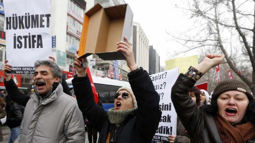 A demonstrator holds a shoe box, as a reference to what the media said are shoe boxes of cash found in the house of Halkbank CEO Suleyman Aslan, during a demonstration against Turkey's ruling Ak Party (AKP) and Prime Minister Tayyip Erdogan in Ankara December 21, 2013. Sixteen people, including the sons of two ministers, were charged on Saturday in connection with a Turkish corruption investigation that has struck at the heart of the ruling elite and threatened the authority of  Erdogan. The general manager