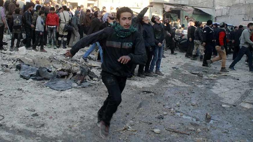 People run after what activists said was the return of government jet planes in Aleppo's al-Marja district December 23, 2013. More than 300 people have been killed in a week of air raids on the northern Syrian city of Aleppo and nearby towns by President Bashar al-Assad's forces, a monitoring group said on Monday. Many of the casualties, who included scores of women and children, were killed by so-called barrel bombs dropped from helicopters, the Syrian Observatory for Human Rights said.   REUTERS/Saad AboB