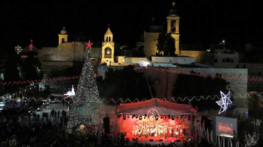 A general view shows Manger Square, near the Church of Nativity, the site revered as the birthplace of Jesus, during Christmas celebrations in the West Bank town of Bethlehem December 24, 2013. REUTERS/Ammar Awad (WEST BANK - Tags: RELIGION) - RTX16TEF