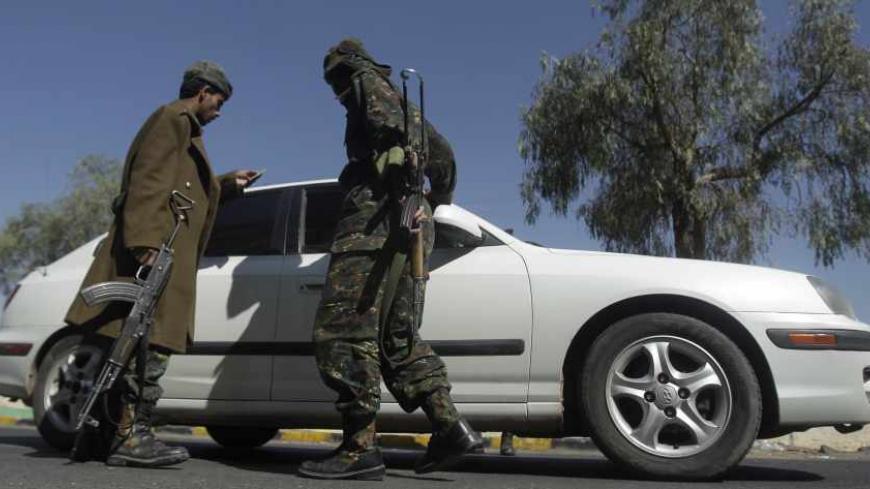 Police troopers inspect a car at a checkpoint in Sanaa December 25, 2013. REUTERS/Khaled Abdullah (YEMEN - Tags: POLITICS MILITARY) - RTX16TRY