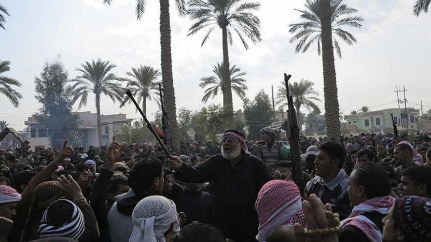 Residents gather to protest near the house of prominent Sunni Muslim lawmaker Ahmed al-Alwani, in the centre of Ramadi, December 29, 2013. Iraqi security forces arrested Alwani in a raid on his home in the western province of Anbar, sparking clashes in which at least five people were killed, police sources said. Picture taken December 29, 2013.  REUTERS/Ali al-Mashhadani (IRAQ - Tags: POLITICS CIVIL UNREST) - RTX16X7L