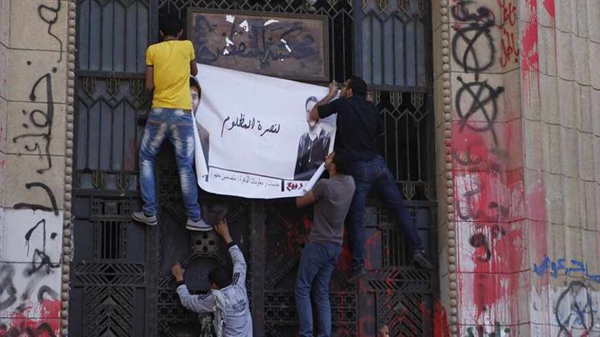 Islamist protesters and activists from the "Ahrar movement" hold a banner of detained fellow demonstrators during a protest supporting them, against the Interior Ministry and members of the Brotherhood in front of the prosecutor-general's office in Cairo April 11, 2013. The demonstrators say the detainees were arrested during protests on April 9 outside Mansoura College. REUTERS/Amr Abdallah Dalsh (EGYPT - Tags: POLITICS CIVIL UNREST CRIME LAW) - RTXYHKW
