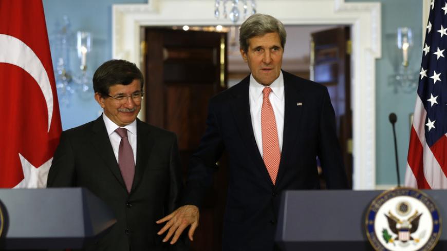 U.S. Secretary of State John Kerry and Turkish Foreign Minister Ahmet Davutoglu (L) arrive to speak to reporters at the State Department in Washington November 18, 2013. REUTERS/Kevin Lamarque  (UNITED STATES - Tags: POLITICS) - RTX15J4C