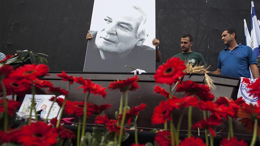 A placard depicting Israeli singer Arik Einstein is placed atop his coffin ahead of a memorial ceremony before his funeral at Rabin square in Tel Aviv November 27, 2013. For many Israelis, nothing symbolised home more than singer Einstein, and on Wednesday a nation mourned the death of its king of cool. Einstein died of a ruptured aneurysm on Tuesday night at the age of 74. REUTERS/Nir Elias (ISRAEL - Tags: SOCIETY ENTERTAINMENT OBITUARY) - RTX15UZH
