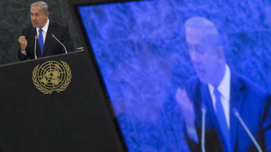 Israel's Prime Minister Benjamin Netanyahu, also seen on a television monitor, addresses the 68th session of the United Nations General Assembly in New York October 1, 2013. Netanyahu said on Tuesday the only way to peacefully stop Iran from developing nuclear weapons is to combine tough sanctions with a credible military threat and that Israel was ready to stand alone in defending itself. REUTERS/Adrees Latif (UNITED STATES - Tags: POLITICS) - RTR3FHF1