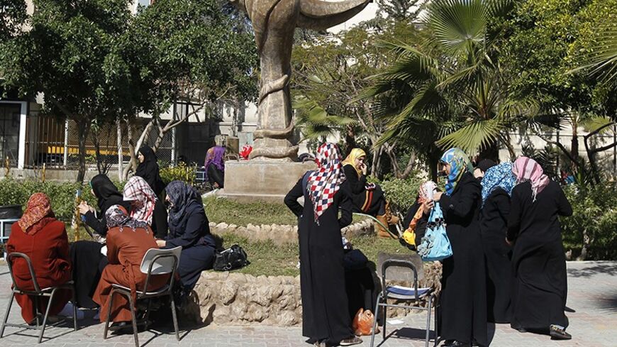Palestinian students gather in the campus of Al-Aqsa University in Gaza City on February 21, 2013. The university has denied reports that it has decided to impose a "strict" Islamic dress code on female students. AFP PHOTO/MOHAMMED ABED        (Photo credit should read MOHAMMED ABED/AFP/Getty Images)