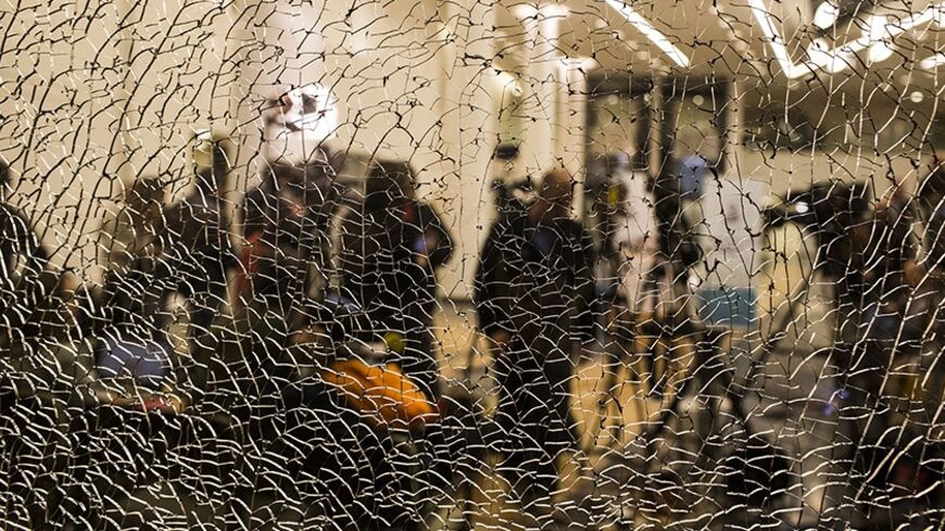 TEL AVIV, ISRAEL - JANUARY 09:  Members of the press are seen through a cracked window while waiting for an update on Former PM Ariel Sharon's condition at the Tel Hashomer hospital on January 9, 2014 near Tel Aviv, Israel. according to Prof. Zeev Rotstein the director general of the Tel Hashomer hospital PM Ariel Sharon's condition is critical and he is suffering from a multiple organ failure,Sharon, 85, is hospitalised in Tel Hashomer hospital near Tel Aviv, and has been comatose since January 4, 2006 whe