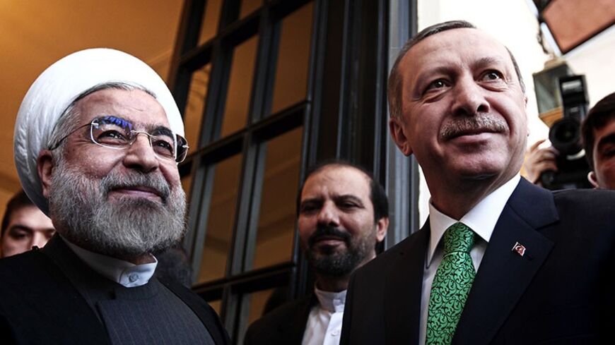 Iranian President Hassan Rouhani (L) greets Turkish Prime Minister Recep Tayyip Erdogan (R) at Tehran's Saadabad palace on January 29, 2014. Erdogan's visit comes as the two countries are trying to rebuild relations strained by the situation in Syria, with Iran supporting President Bashar al-Assad while Turkey backs the rebels seeking to oust him. AFP PHOTO/BEHROUZ MEHRI        (Photo credit should read BEHROUZ MEHRI/AFP/Getty Images)