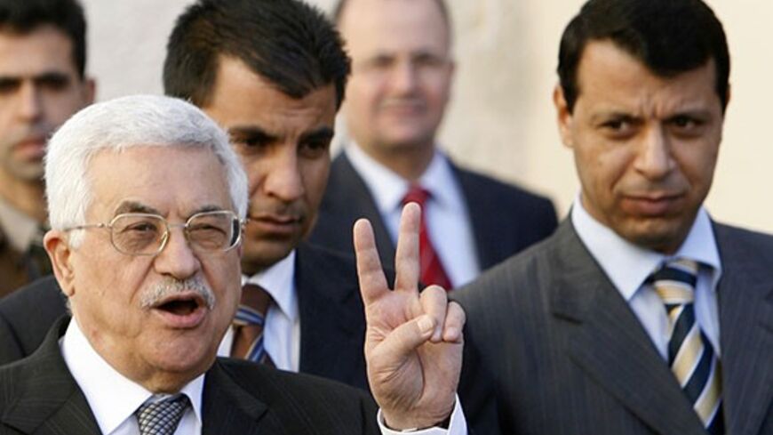 Palestinian President Mahmoud Abbas (L) gestures as Fatah strongman and lawmaker Mohammed Dahlan looks on (R) after meeting with British Prime Minister Tony Blair at the Palestinian Authority headquarters in the West Bank city of Ramallah December 18, 2006. Abbas told Blair on Monday he would push on with plans for early elections despite bitter opposition from the Hamas government. Blair said it was critical that the international community supported the moderate Abbas in the coming weeks. REUTERS/Eliana A