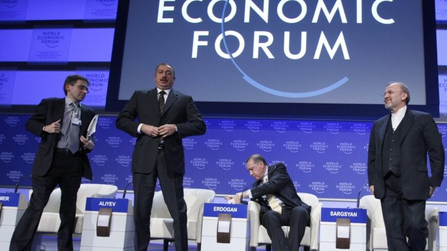 Ian Bremmer, President, Eurasia Group, U.S.A., Azerbaijan's President Ilham Aliyev, Turkey's Prime Minister Tayyip Erdogan and Iran's Foreign Minister Manouchehr Mottaki (L-R) attend a session at the World Economic Forum (WEF) in Davos January 29, 2009. Business leaders and policymakers meeting in Davos turn their attention to financial regulation, energy, trade and global security after hearing China and Russia blame debt-fuelled consumption for massive financial collapse. REUTERS/Pascal Lauener   (SWITZER