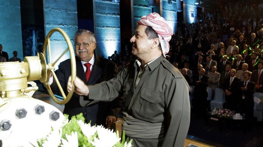 Kurdish President Massoud Barzani (C) and Iraqi President Jalal Talabani open a ceremonial valve during an event to mark the official start of oil exports from the autonomous region of Kurdistan, in the northern Kurdish city of Arbil June 1, 2009. Iraq's Kurdistan region said on Monday it hoped to be producing 1 million barrels per day of oil within the next 2-3 years, despite discord with the Arab-led government in Baghdad over Iraq's oil wealth.  REUTERS/Safin Hamed/Pool (IRAQ CONFLICT POLITICS ENERGY BUS