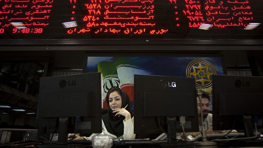 EDITORS' NOTE: Reuters and other foreign media are subject to Iranian restrictions on their ability to film or take pictures in Tehran. An Iranian official works at her desk in the main hall of the Tehran Stock Exchange August 3, 2010. Sanctions against Iran have done nothing to dent a boom in its stock market, as investors bet on a continued rise in company stocks which have been undervalued for years, the head of the Tehran bourse said. REUTERS/Morteza Nikoubazl (IRAN - Tags: BUSINESS POLITICS) - RTR