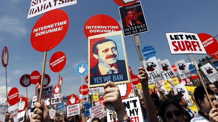 Demonstrators hold placards with some featuring a picture of Turkey's Prime Minister Tayyip Erdogan during a protest against internet censorship in Istanbul May 15, 2011. Thousands of people marched in central Istanbul to protest against the government's plan to filter the internet. REUTERS/Murad Sezer (TURKEY - Tags: CIVIL UNREST POLITICS) TEMPLATE OUT - RTR2MG6S