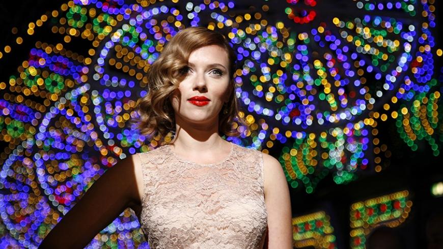 Actress Scarlett Johansson poses for photographers on the catwalk before the Dolce & Gabbana Spring/Summer 2012 women's collection during Milan Fashion Week September 25, 2011.   REUTERS/Alessandro Garofalo (ITALY - Tags: FASHION ENTERTAINMENT) - RTR2RTN6