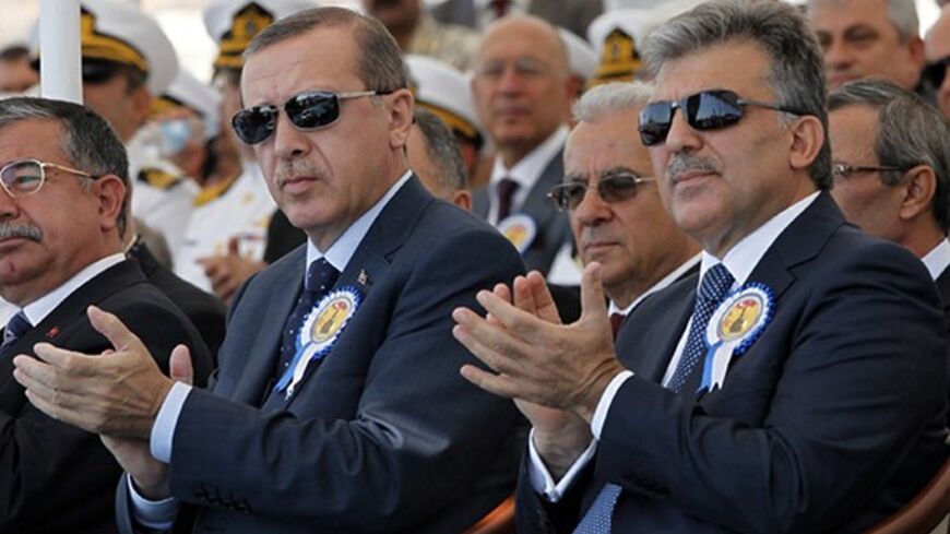 Turkey's President Abdullah Gul (R) and Turkey's Prime Minister Recep Tayyip Erdogan attend a delivery ceremony for the first nationally designed combat ship TCG Heybeliada at the Tuzla Naval shipyard in Istanbul September 27, 2011.  REUTERS/Osman Orsal (TURKEY - Tags: POLITICS MILITARY) - RTR2RWLG
