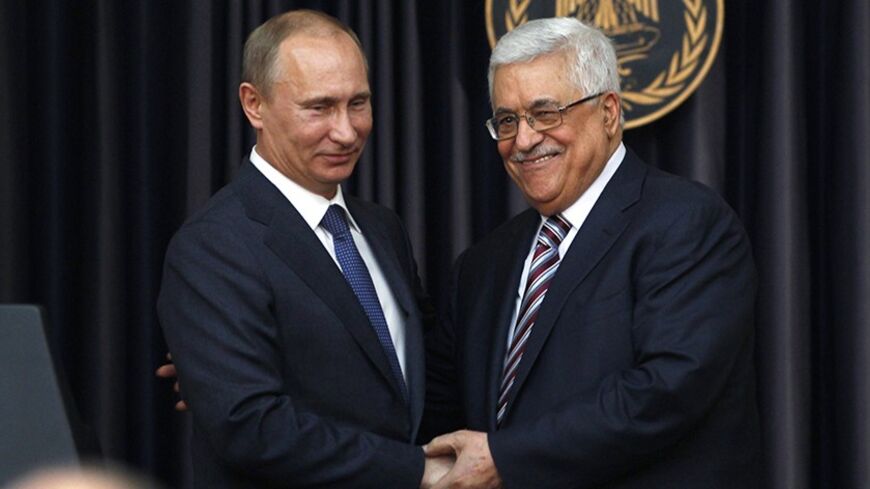 Palestinian President Mahmoud Abbas (R) shakes hands with his Russian counterpart Vladimir Putin after delivering joint statements  in the West Bank town of Bethlehem June 26, 2012. REUTERS/Darren Whiteside (WEST BANK - Tags: POLITICS) - RTR3461J