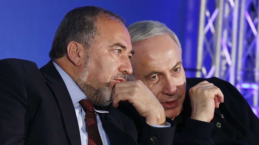 Israel's Prime Minister Benjamin Netanyahu (R) converses with former Foreign Minister Avigdor Lieberman during a Likud-Yisrael Beitenu campaign rally in the southern city of Ashdod January 16, 2013. Netanyahu's right-wing Likud party, allied with the nationalist Yisrael Beitenu party, continues to lead opinion polls ahead of Israel's Jan. 22 parliamentary election. REUTERS/Amir Cohen (ISRAEL - Tags: POLITICS ELECTIONS) - RTR3CJ8M