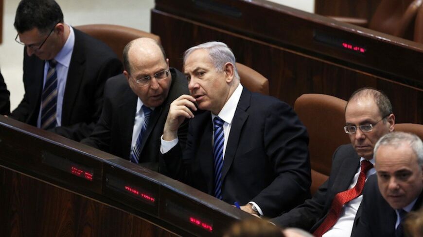 Israel's Prime Minister Benjamin Netanyahu (3rd L) and Defence Minister Moshe Yaalon (2nd L) speak during the swearing-in ceremony, at the Knesset, the Israeli Parliament, in Jerusalem March 18, 2013. Netanyahu's new governing coalition took office after a parliamentary vote on Monday with powerful roles reserved for supporters of settlers in occupied territory. REUTERS/Baz Ratner (JERUSALEM - Tags: POLITICS) - RTR3F5XR