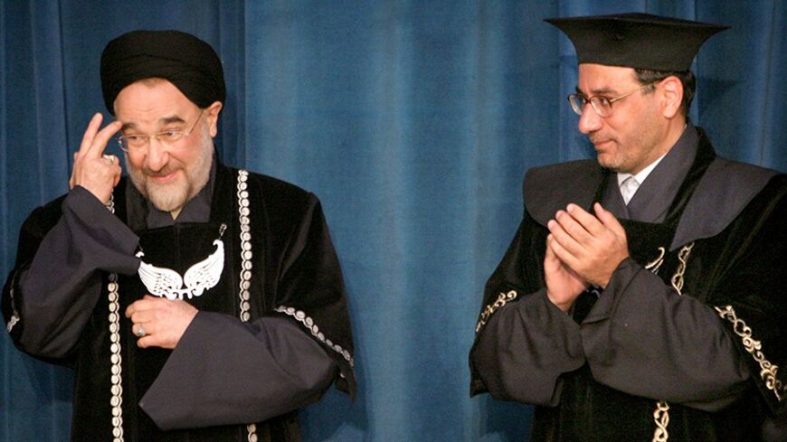 Dr. Faraji Dana claps as Iranian President Mohammad Khatami receives his honorary international relations doctorate in Tehran.  Dr. Faraji Dana (R), president of Tehran University, claps as Iranian President Mohammad Khatami receives his honorary international relations doctorate from Tehran University April 27, 2005. REUTERS/Morteza Nikoubazl - RTR9DQU