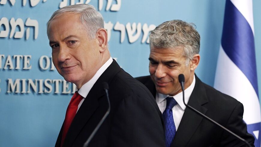 Israeli Prime Minister Benjamin Netanyahu (L) and Finance Minister Yair Lapid leave after a joint news conference in Jerusalem July 3, 2013. Israel initiated a tender for two new private seaports to operate beside existing government-owned ports in Haifa and Ashdod in a bid to stir up competition and lower the costs of good in Israel. Each new port will cost about $1 billion to build. REUTERS/Ronen Zvulun (JERUSALEM - Tags: POLITICS) - RTX11AV6