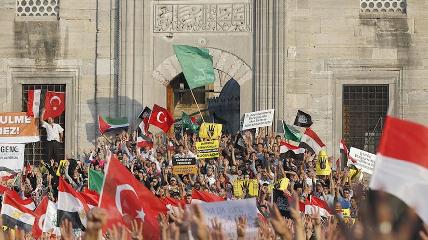 Supporters of Egypt's deposed Islamist President Mohamed Mursi and the Muslim Brotherhood wave Turkish and Egyptian flags during a rally in protest against the recent violence in Egypt, outside of the Eminonu New mosque in Istanbul August 17, 2013. REUTERS/Murad Sezer (TURKEY  - Tags: POLITICS CIVIL UNREST) - RTX12P97