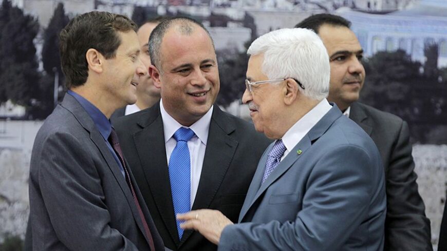 Israeli parliament members Isaac Herzog (L) and Hilik Bar (C) shake hands with Palestinian President Mahmoud Abbas as they attend a meeting in the West Bank city of Ramallah October 7, 2013. Abbas held a rare meeting with the group of Israeli parliamentarians on Monday, warning that this could be the last chance to reach a deal to end decades of Israeli-Palestinian conflict and create two independent states living side-by-side. REUTERS/Abbas Momani/Pool (WEST BANK - Tags: POLITICS) - RTX142QP