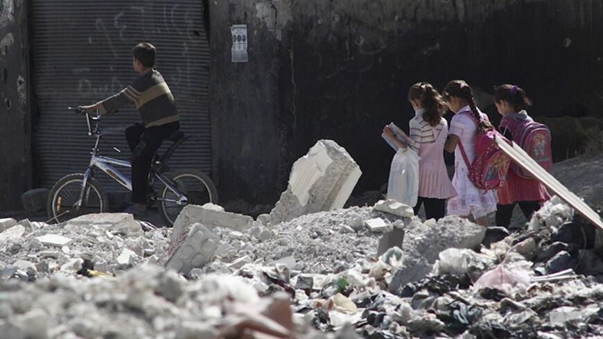 Children go to school on a damaged street in Duma neighbourhood in Damascus October 12, 2013. REUTERS/Bassam Khabieh (SYRIA - Tags: POLITICS CIVIL UNREST CONFLICT TPX IMAGES OF THE DAY EDUCATION) - RTX148Z5