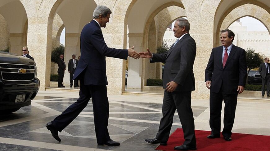 Jordan's Foreign Minister Nasser Judeh (C) welcomes U.S. Secretary of State John Kerry upon his arrival at the Royal Palace in Amman, to meet with Jordan's King Abdullah, November 7, 2013. At right is U.S. Ambassador to Jordan Stuart Jones. REUTERS/Muhammad Hamed (JORDAN - Tags: POLITICS) - RTX153OT