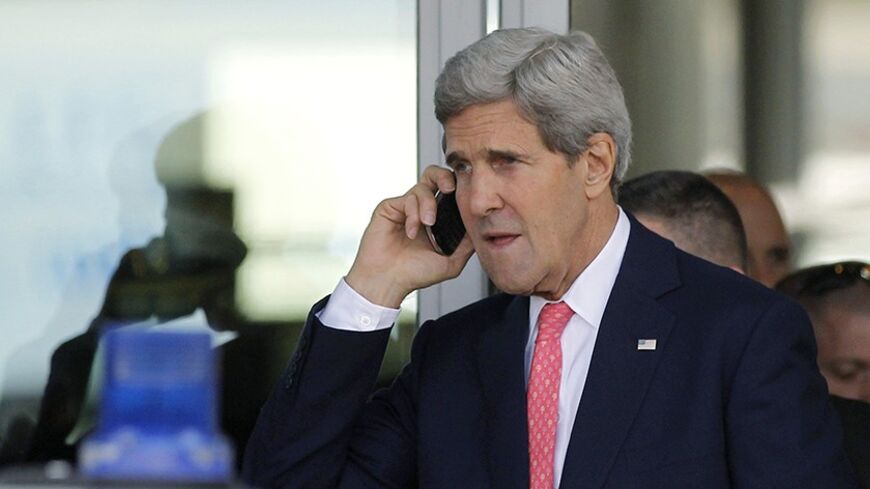 U.S. Secretary of State John Kerry speaks on a mobile phone after his private meeting with Israeli Prime Minister Benjamin Netanyahu in Tel Aviv November 8, 2013.  REUTERS/Jason Reed (ISRAEL - Tags: POLITICS) - RTX1553L