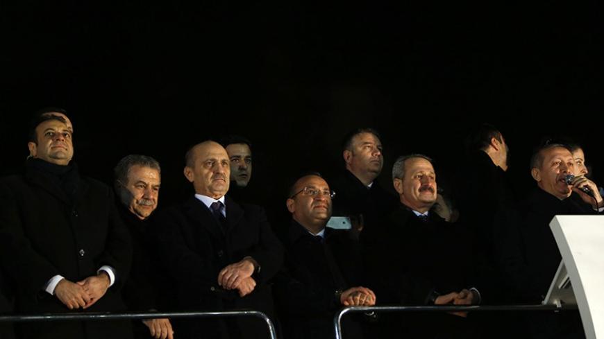(From L to R) Turkey's European Affairs Minister Egemen Bagis, Interior Minister Muammer Guler, Environment and City Planning Minister Erdogan Bayraktar, Deputy Prime Minister Bekir Bozdag  and Economy Minister Zafer Caglayan listen as Prime Minister Tayyip Erdogan addresses his supporters at Esenboga Airport in Ankara December 24, 2013. Turkish ministers Caglayan and Guler resigned on Wednesday after their sons were arrested in a corruption investigation that has pitted the government against the judiciary