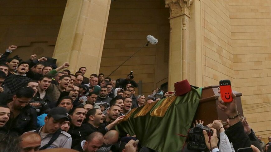People carry the coffin of former Lebanese minister Mohamad Chatah's bodyguard Tarek Badr, who was killed in a bomb blast on Friday, during his mass funeral at al-Amin mosque in Martyrs' Square in downtown Beirut December 29, 2013. Chatah, who opposed Syrian President Bashar al-Assad, was killed in the attack which one of his political allies blamed on Lebanon's Shi'ite Hezbollah militia. REUTERS/Jamal Saidi (LEBANON - Tags: POLITICS CIVIL UNREST OBITUARY) - RTX16WAX