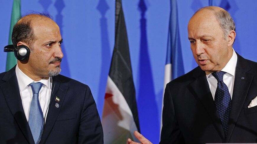 French Foreign Affairs Minister Laurent Fabius (R) and Ahmad Jarba, leader of Syria's opposition National Coalition, attend a news conference at the French foreign ministry during a "Friends of Syria" meeting ahead of Geneva II peace talks, in Paris, January 12, 2014. The "Friends of Syria", an alliance of mainly Western and Gulf Arab countries who oppose Syrian President Bashar al-Assad, urged opposition groups on Sunday to attend this month's peace talks, saying there was no alternative for a political so