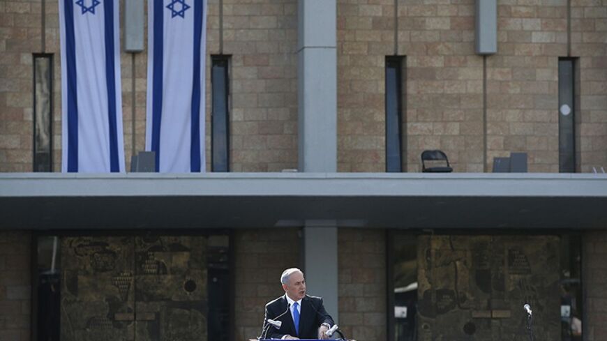 Israel's Prime Minister Benjamin Netanyahu speaks during a memorial ceremony for former Israeli Prime Minister Ariel Sharon at the Knesset, Israel's parliament, in Jerusalem January 13, 2014. Israel paid homage to Sharon at the first of two funeral services to be held on Monday for a man hailed as a war hero at home but seen by many in the Arab world as a war criminal. REUTERS/Ronen Zvulun (JERUSALEM - Tags: POLITICS OBITUARY) - RTX17C56
