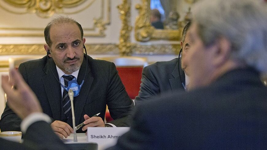 Syrian National Coalition Chief Ahmad al-Jarba (L) listens to U.S. Secretary of State John Kerry during the start of their meeting at the U.S. Ambassador residence in Paris January 13, 2014. Syria's government and some rebels may be willing to permit humanitarian aid to flow, enforce local ceasefires and take other confidence-building measures in the nearly three-year-old civil war, Kerry said on Monday.   REUTERS/Pablo Martinez Monsivais/Pool   (FRANCE - Tags: POLITICS) - RTX17CPS